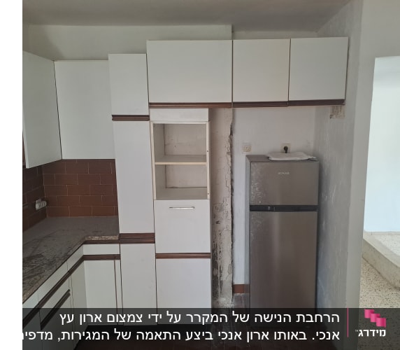 מטבח בעל ארונות לבנים עם גימור עץ ומשטח שיש